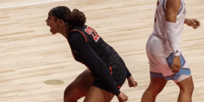 Una mujer celebrando en una cancha de baloncesto.