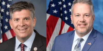 Darin LaHood y Eric Sorensen frente a una bandera de estados unidos.